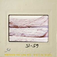 Close-up photograph of a pottery break surface on a film strip.