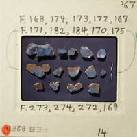 A collection of small, colorful rocks displayed on a dark background.