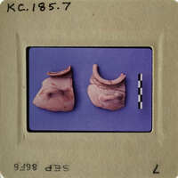 Two ancient clay figurines on display.