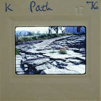 A photograph of a rocky path with a vintage film strip border.