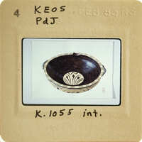 An antique bowl with intricate patterns and designs, photographed against a white background.