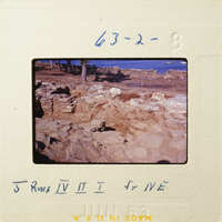 "Ancient ruins with stones and dirt, possibly from an archaeological site."