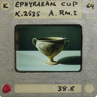 Ornate, antique cup (K.2535) on pedestal with two handles and intricate designs.