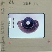 Base of pot K.2181 from bottom, fragment only on white surface.