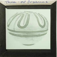 Ancient ceramic pot with decorative patterns on display.