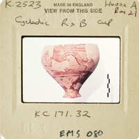 Ancient Greek vase with visible cracks and chips, displayed against a white background.