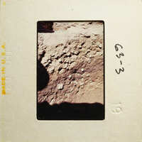 Close-up photograph of rock surface with various textures and patterns.