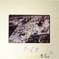 A photograph showing an ancient archaeological site with rock formations and ruins.