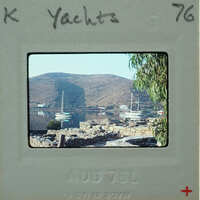 Picture of a harbor with boats and mountains, taken on August 7th, 1976.
