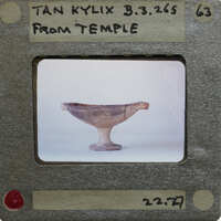 A kylix with a label indicating it's from Temple, displayed on a table.